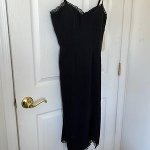 Black cocktail dress with lace trim and small slit